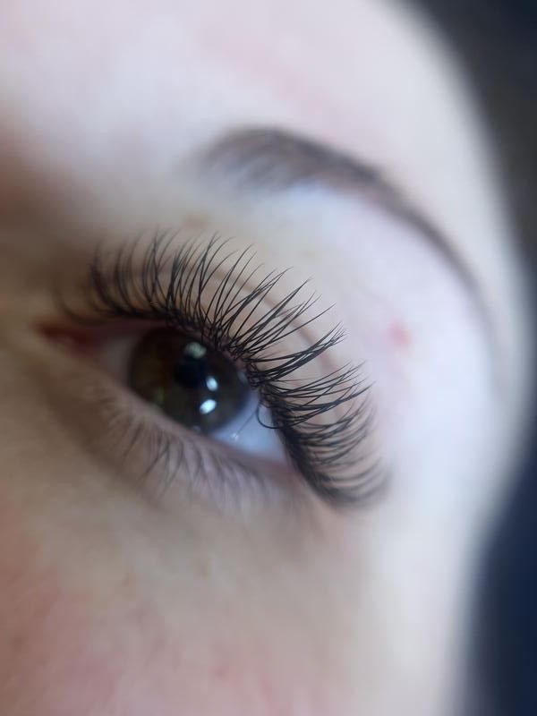 Wispy lash extensions on a brown eye